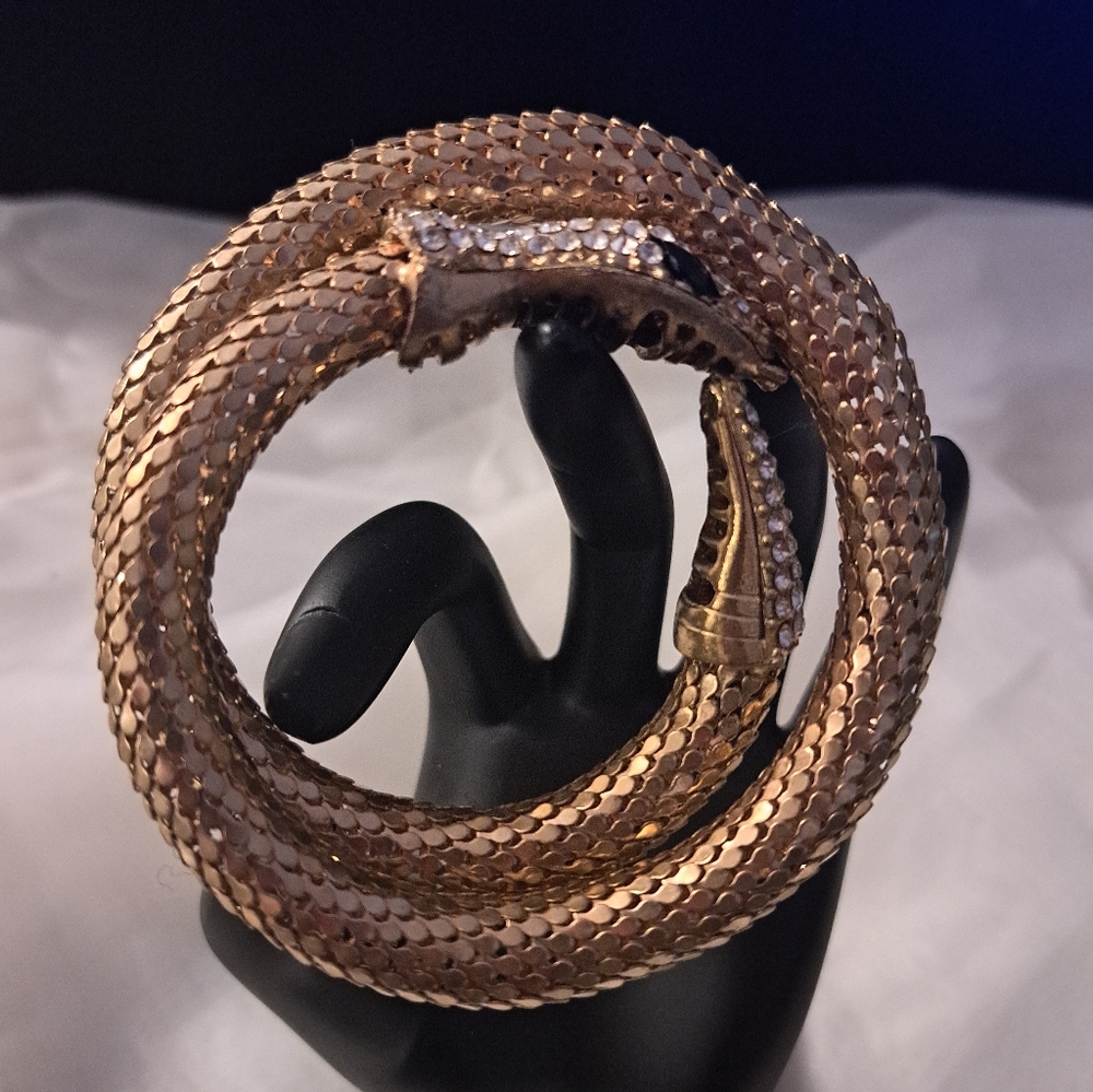 Luxurious Gold Tone Snake Bracelet with Crystal Accents.